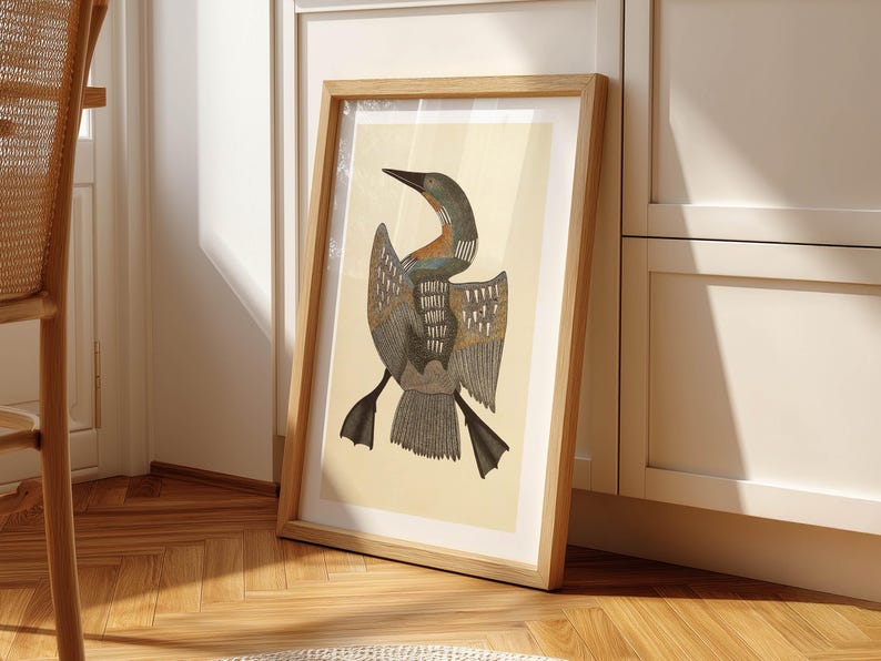 May include: A framed art print featuring a stylized illustration of a bird with outstretched wings. The bird has a long neck and beak, with detailed feather patterns in shades of gray, brown, and teal. The artwork is set against a cream-colored background.