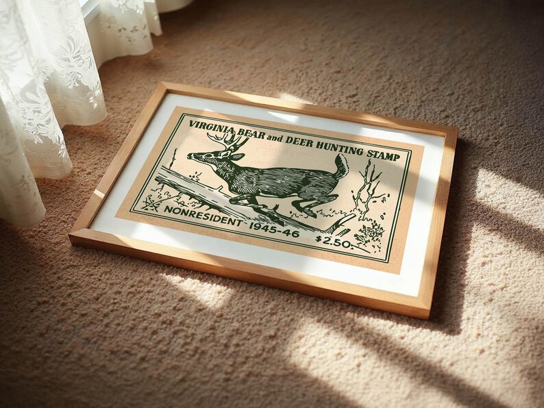May include: Framed vintage print of a deer hunting stamp. The artwork features a detailed illustration of a deer leaping over a log, with text that reads "VIRGINIA BEAR and DEER HUNTING STAMP" and "NONRESIDENT 1945-46". The frame is made of light-colored wood.