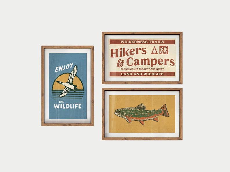May include: Three framed art prints with a nature theme. One print says "Enjoy the Wildlife" with a duck graphic. Another says "Hikers & Campers" with text about preserving land. The third print features a fish.