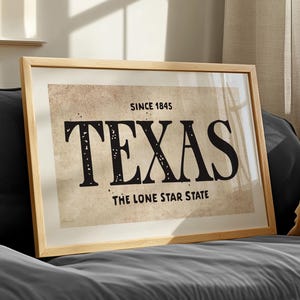 May include: A framed print with a vintage aesthetic featuring the text "Since 1845 Texas The Lone Star State" in black lettering on a beige background.