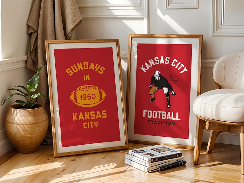 May include: Two framed posters with red backgrounds and gold lettering. The poster on the left says "Sundays in 1960 Kansas City" with a football graphic. The poster on the right says "Kansas City 1960 Football Tradition" with a football player graphic.