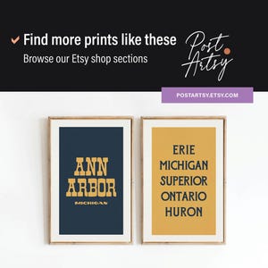 May include: Two framed prints with text. One print features "Ann Arbor, Michigan" in gold lettering on a navy blue background. The other print displays "Erie, Michigan, Superior, Ontario, Huron" in black on a yellow background.