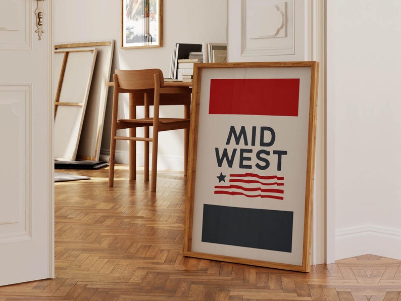 May include: A framed print with a red, white, and blue design. The print features the text "MID WEST" and a stylized American flag. The frame is made of wood and has a natural finish.