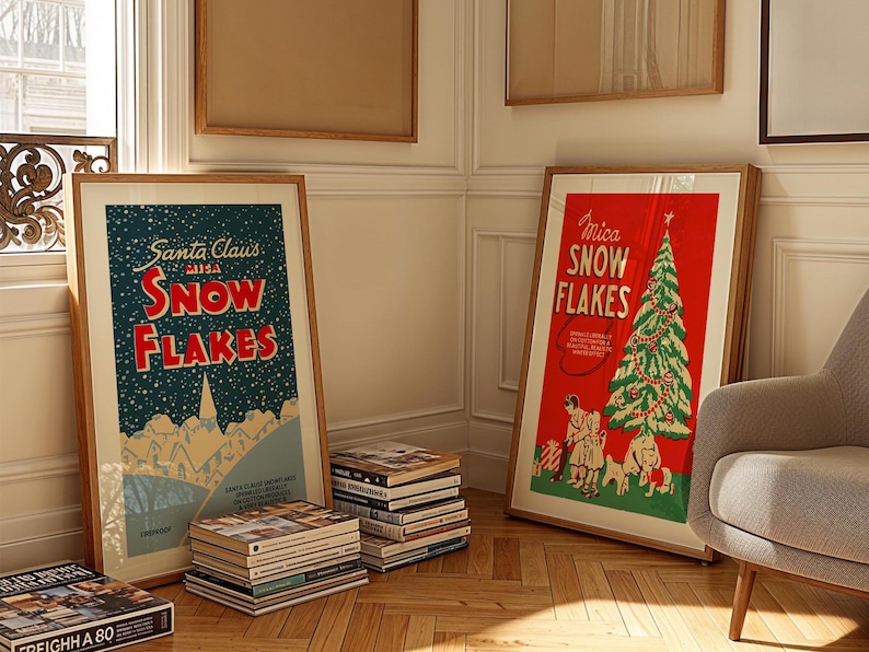 May include: Two framed vintage Christmas posters with the text "Santa Claus 1913 Snowflakes" and "Mica Snowflakes" on a light wood floor. The poster on the left features a snowy mountain scene with a town in the distance. The poster on the right features a red background with a green Christmas tree decorated with ornaments and a star on top.