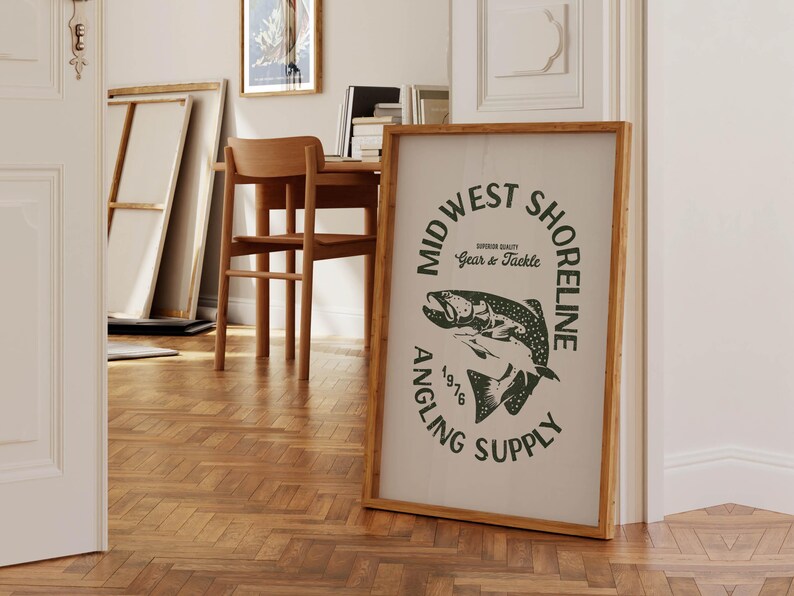 May include: A framed print with a black and white illustration of a fish. The text on the print reads "Mid West Shoreline Angling Supply Superior Quality Gear & Tackle 1976".