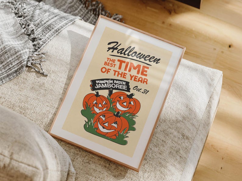May include: Framed Halloween poster with a vintage design. The poster features the text "Halloween, the best time of the year" and "Pumpkin Patch Jamboree Oct. 31" with illustrations of smiling orange pumpkins. The frame is a light brown color.