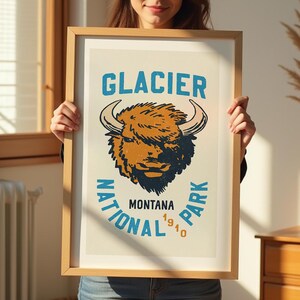 Pu&ograve; includere: Un poster in stile vintage con un bordo blu e bianco che presenta una testa di bisonte marrone e bianca con il testo "GLACIER NATIONAL PARK MONTANA 1910" in un cerchio blu.