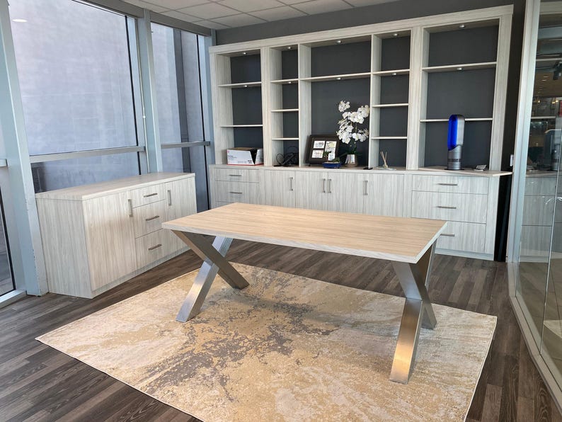 Axis Brushed Stainless Steel X-Frame Table Legs under a light wood top