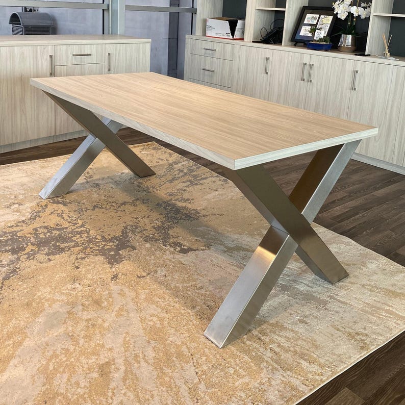 Axis Brushed Stainless Steel X-Frame Table Legs under a light wood top