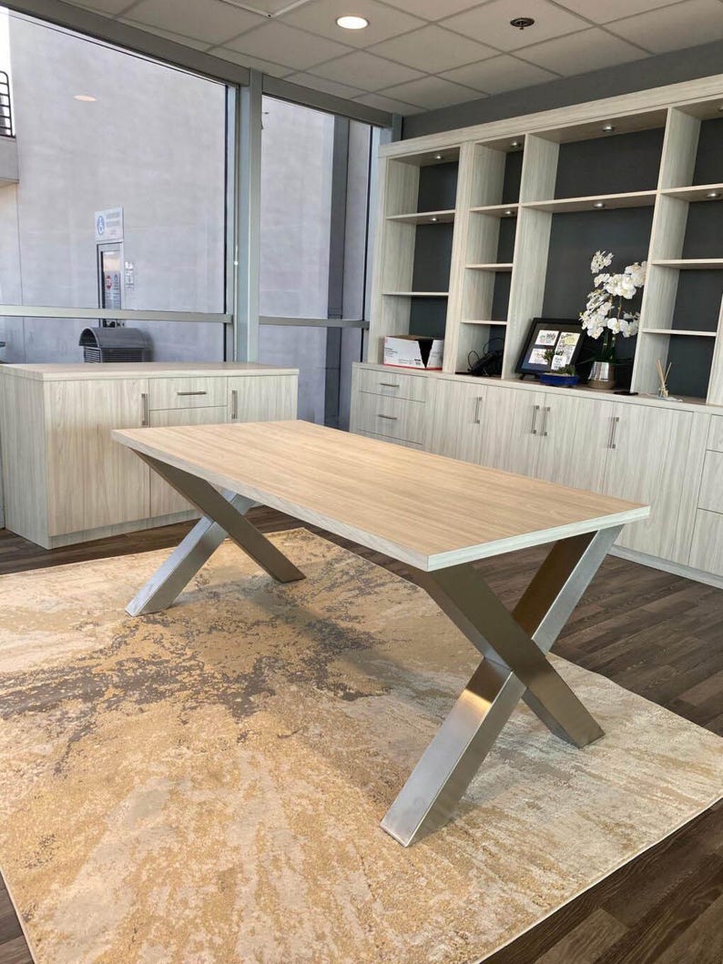 Axis Brushed Stainless Steel X-Frame Table Legs under a light wood top