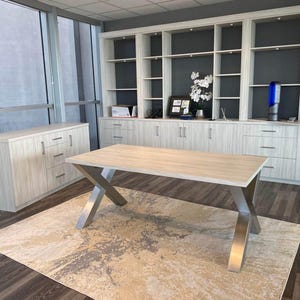 Axis Brushed Stainless Steel X-Frame Table Legs under a light wood top