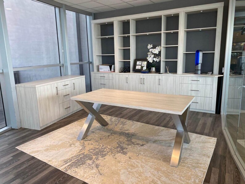 Axis Brushed Stainless Steel X-Frame Table Legs under a light wood top