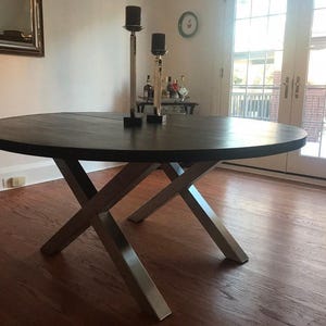 Axis Brushed Stainless Steel X-Frame Table Legs under a dark wood round top