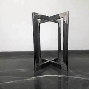 May include: A black metal table base with a square top and four legs. The legs are connected in the middle with a cross shape.