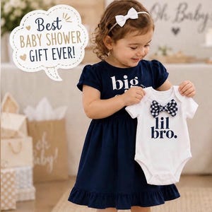May include: A navy blue short-sleeved dress with the text big and a white short-sleeved bodysuit with the text lil bro. The white bodysuit features a navy and white gingham patterned bow tie at the neckline. A white speech bubble contains the text Best BABY SHOWER GIFT EVER!