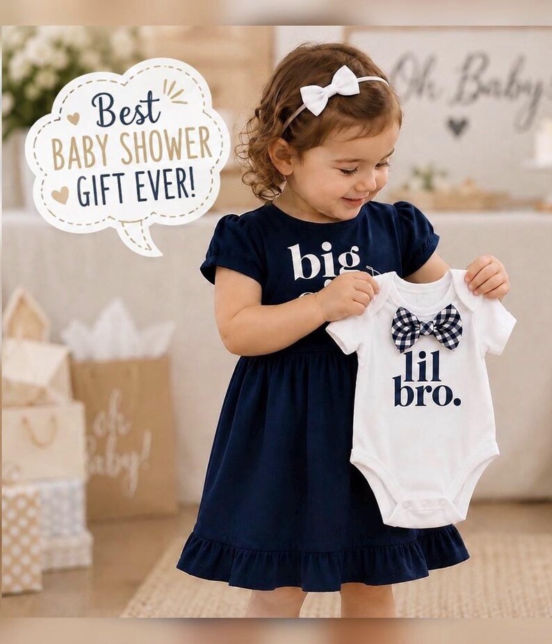 May include: A navy blue short-sleeved dress with the text big and a white short-sleeved bodysuit with the text lil bro. The white bodysuit features a navy and white gingham patterned bow tie at the neckline. A white speech bubble contains the text Best BABY SHOWER GIFT EVER!