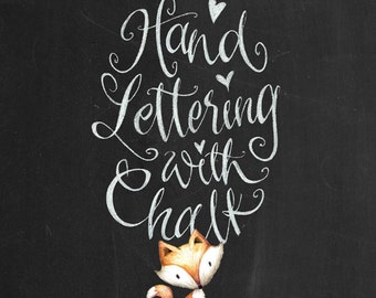 May include: Hand lettering with chalk on a black chalkboard background. The text reads "Hand Lettering & with Chalk". A small orange fox is looking up at the text.