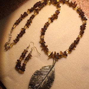 Bold feather focal necklace with earrings.