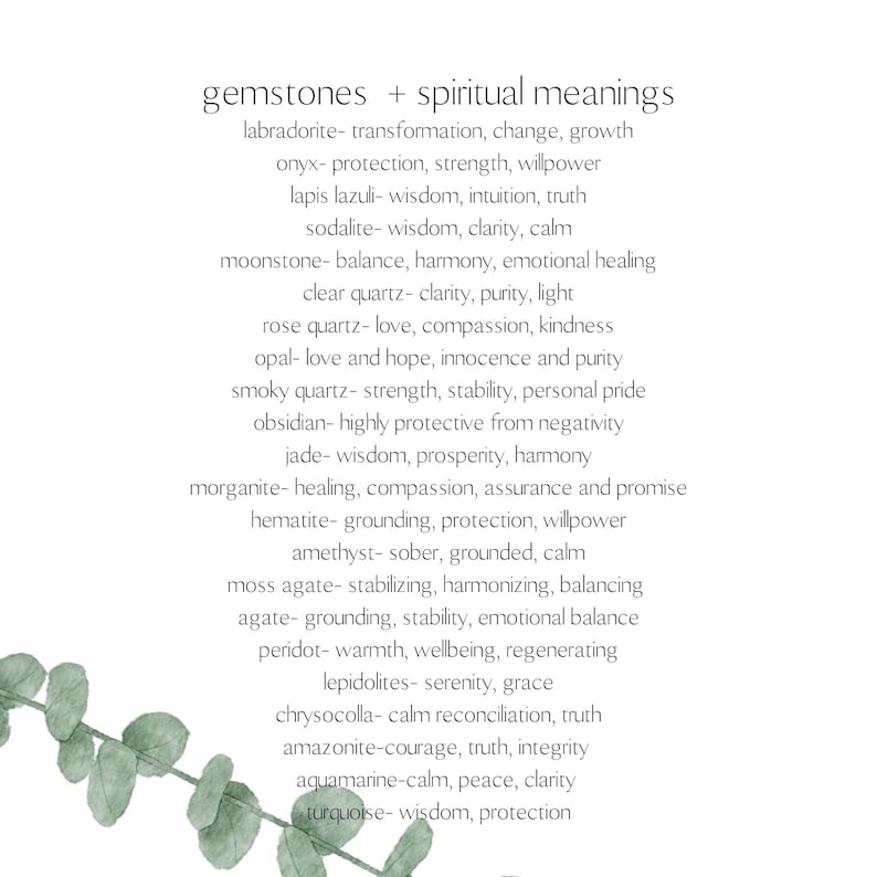 May include: A white background with the text "gemstones + spiritual meanings" and a list of gemstones with their associated meanings. The image includes a sprig of green leaves in the lower left corner.