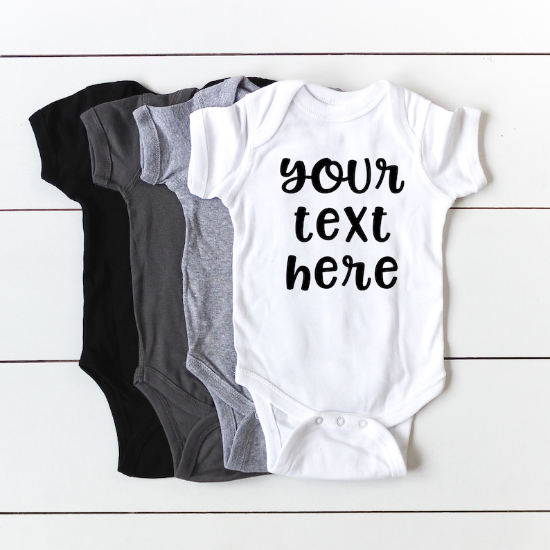 Four baby onesies, each in a different color. These are meant to show color options in designing your own text on the onesies.