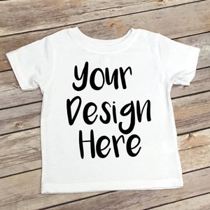 May include: White t-shirt with the text "your design here" in black.