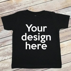 May include: Black t-shirt with the text "Your design here" printed in white on the front.