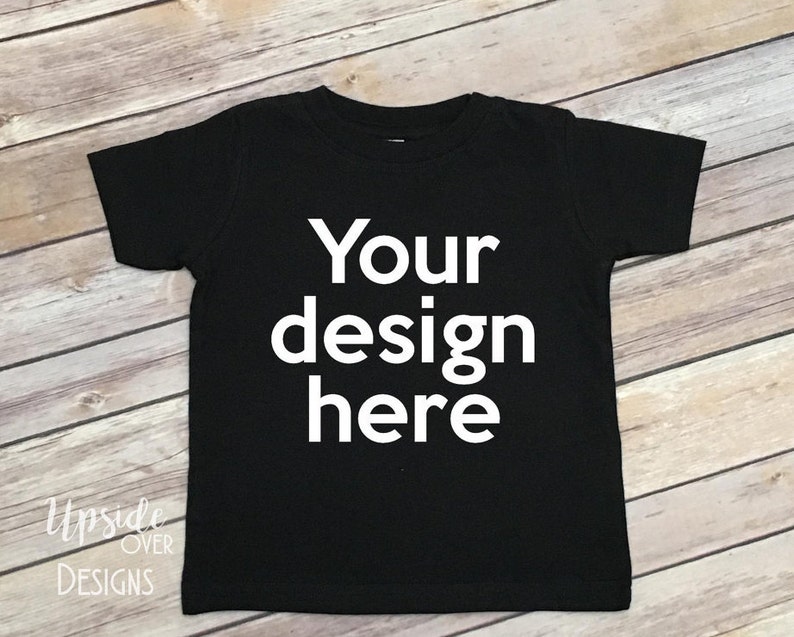 May include: Black t-shirt with the text "Your design here" printed in white on the front.