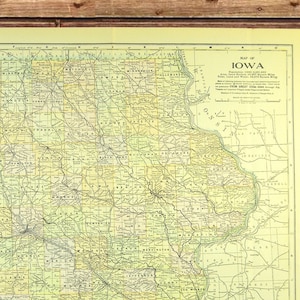May include: A vintage map of Iowa, printed on yellowed paper, with county lines and major cities labeled. The map shows roads and railroads throughout the state.