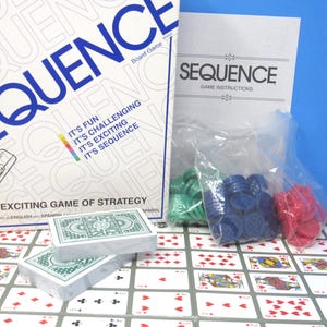 May include: The Sequence board game box features white packaging with blue text, including the title and the phrase It's Fun, It's Challenging, It's Exciting, It's Sequence. Included are two decks of green-backed playing cards, game instructions, and three plastic bags containing green, blue, and red circular game chips on a printed game board.