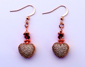 Pave cubic zirconia puffed heart earrings with red crystals and rose gold daisy spacers on rose gold filled French ear wires. handmade