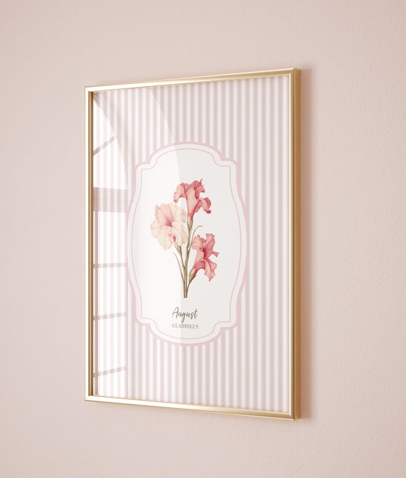 May include: A framed print with a pink and white striped background. The center of the print features a white oval with a pink floral illustration and the text "August GLADIOLUS".