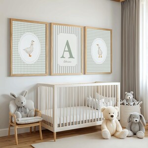May include: Three framed wall art prints featuring a light green and white gingham pattern. The two outer prints display a watercolor illustration of a goose inside an oval frame. The center print features a large letter A and the name Adrian.