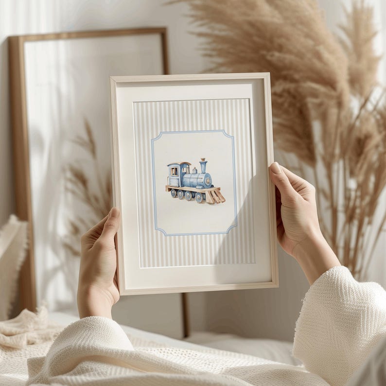May include: A framed print of a blue and white toy train on a white background with blue and white stripes. The train is in a blue and white frame with a blue and white border.
