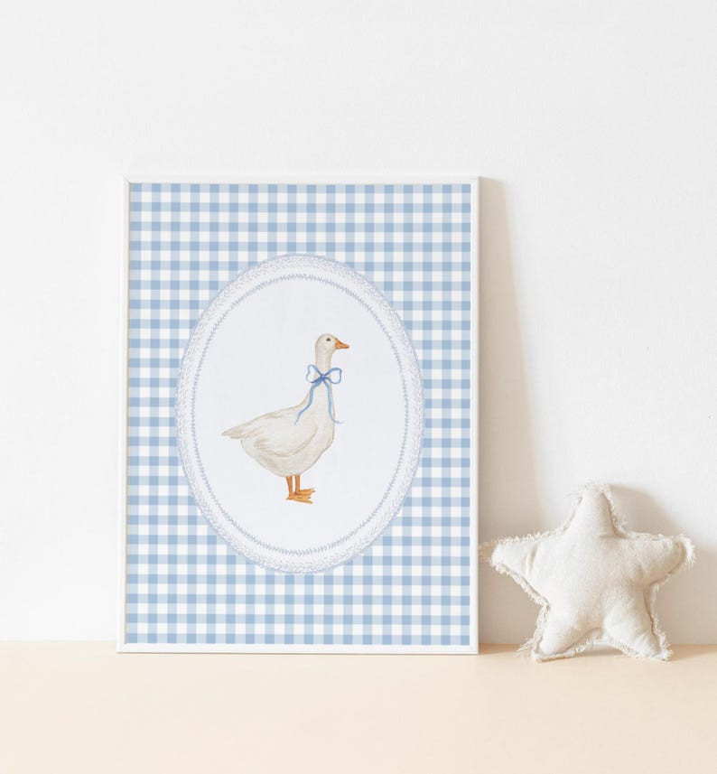May include: A framed print of a white goose with a blue bow on a blue and white gingham background.