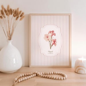 May include: A framed print with a pink and white striped background. The print features a watercolor illustration of pink and white gladiolus flowers with the text "August Gladiolus".