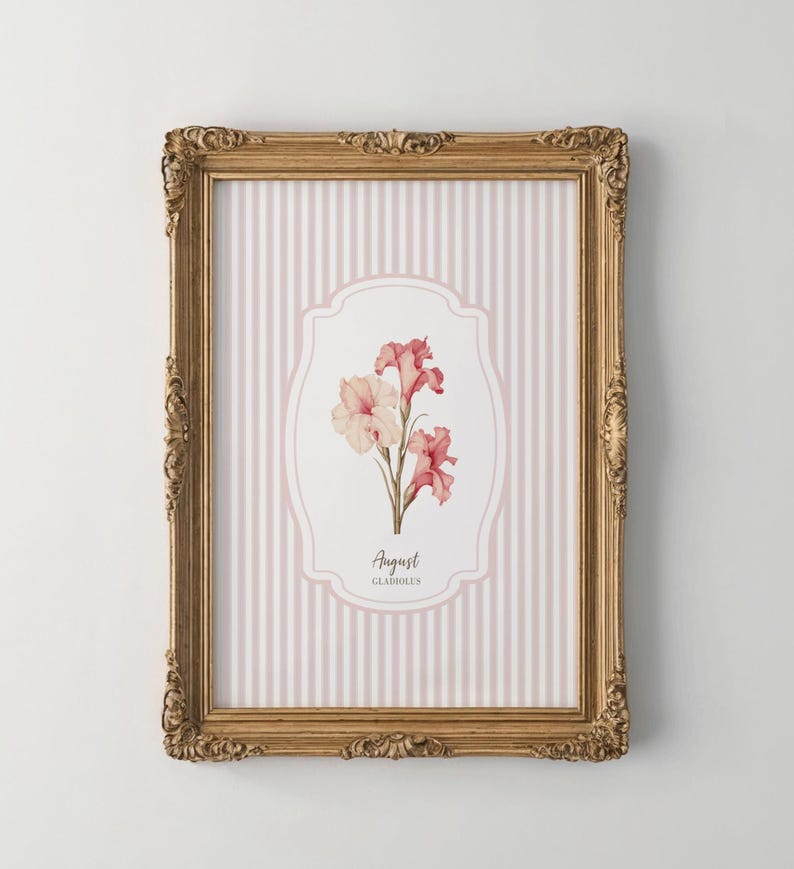 May include: A framed print with a pink and white striped background. The center of the print features a white oval with a pink floral illustration of gladiolus flowers. The text "August Gladiolus" is printed below the flowers.