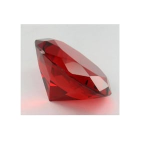 May include: A large, red, faceted crystal diamond. The diamond is made of glass and has a clear, reflective surface.