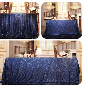 May include: A navy blue sequin table runner with a subtle shimmer. The runner is draped over a table in a room with a staircase and decorative elements.