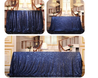 May include: A navy blue sequin table runner with a subtle shimmer. The runner is draped over a table in a room with a staircase and decorative features.