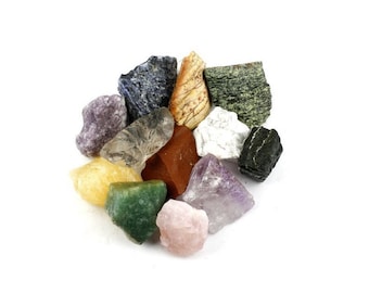 Puede incluir: Una colección de piedras preciosas en bruto y sin cortar de varios colores, incluyendo morado, verde, amarillo, marrón y blanco. Las piedras están dispuestas en forma circular sobre un fondo blanco. Estos cristales naturales son ideales para la fabricación de joyas o coleccionar.