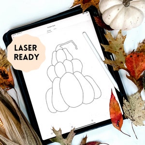 May include: A digital illustration of a stacked pumpkin design, labeled "Pumpkin Stack" on a tablet screen. The image is surrounded by fall foliage, a white pumpkin, and a stylus. The text "LASER READY" is displayed on the left.