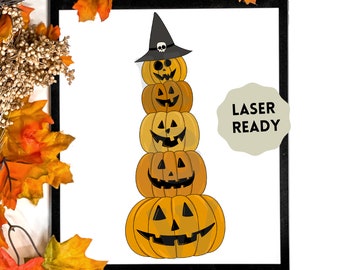 May include: A stack of five orange pumpkins with carved faces, topped with a black witch hat with a skull. The pumpkins are in varying shades of orange and yellow. The image has the text "LASER READY".