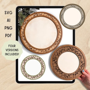 Könnte beinhalten: Auf einem Tablet werden vier kreisförmige Holzrahmen mit floralen Mustern in verschiedenen Braun- und Grüntönen gezeigt. Die Rahmen haben eine leere Mitte. Der Text auf dem Bildschirm lautet "SVG, AI, PNG, PDF" und "FOUR VERSIONS INCLUDED!"