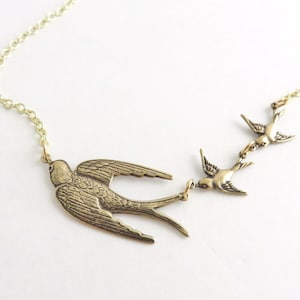 Gold three birds necklace.