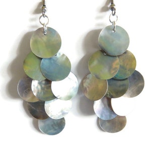 A close up of iridescent mussel shell earrings on a white background.