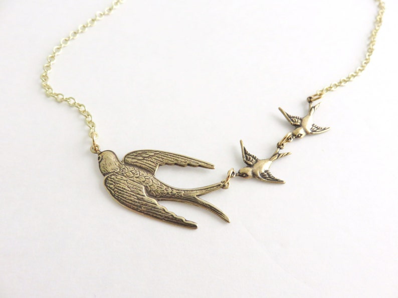 Gold three birds necklace.