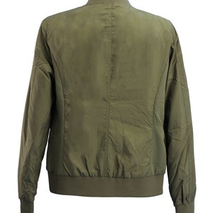 May include: A green bomber jacket with a zipper closure and ribbed cuffs and hem.