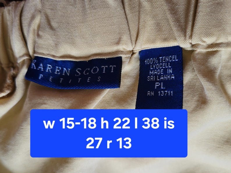 May include: Close-up of a beige garment with a blue label that reads "KAREN SCOTT PETITES". A second blue label indicates the fabric is 100% Tencel Lyocell and made in Sri Lanka. A blue rectangle displays measurements.