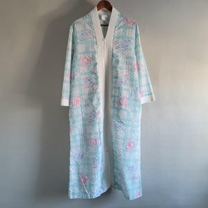 May include: A set of three ceramic mugs with a speckled, matte finish. Each mug features a different color: light blue, cream, and gray. The mugs have a simple, modern design and a comfortable handle.