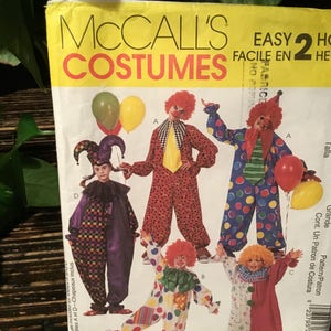 May include: A sewing pattern for making clown costumes. The pattern includes four different clown costumes: a red and white polka dot costume, a purple and black checkered costume, a red and white polka dot costume with a yellow collar, and a white and red striped costume with a yellow collar. The pattern is for sizes 38-40 and is labeled "Easy 2 Hour Costumes".